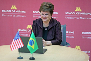 Dean Connie Delaney with flags for US and Brazil